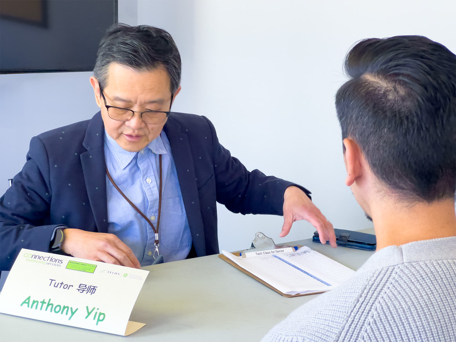 Anthony Yip reviews the attendance sheet before teaching his weekly Digital Literacy for Seniors Class