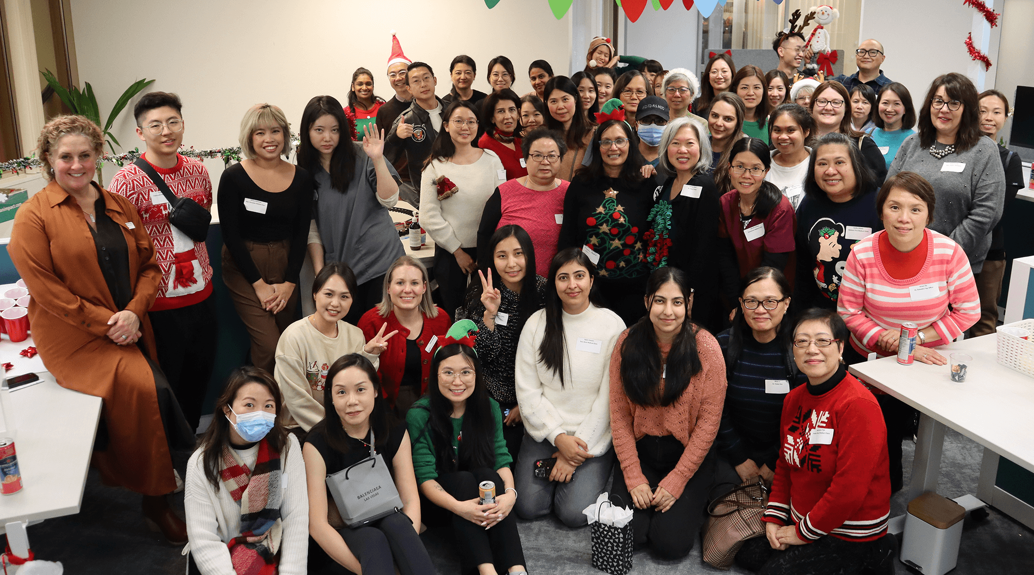 Medical Office Assistant MOA Holiday Social 2023 group shot in holiday sweaters